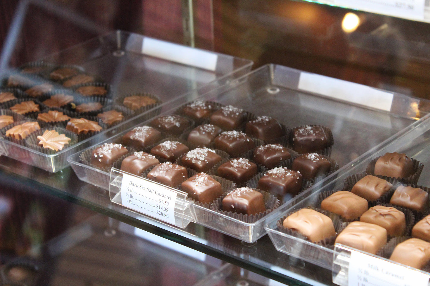 Glass candy case filled with caramels and other chocolates