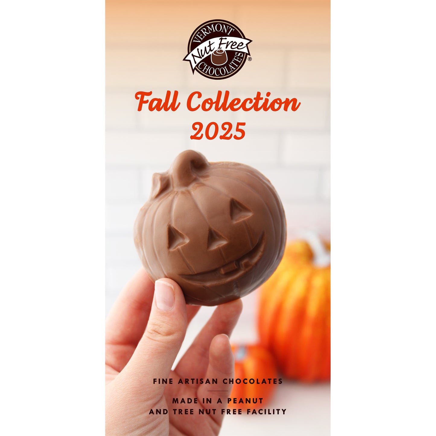 Chocolate pumpkin shaped like a jack-o'-lantern held by a hand, with 'Vermont Nut Free Chocolates' branding and 'Fall Collection 2025' text.