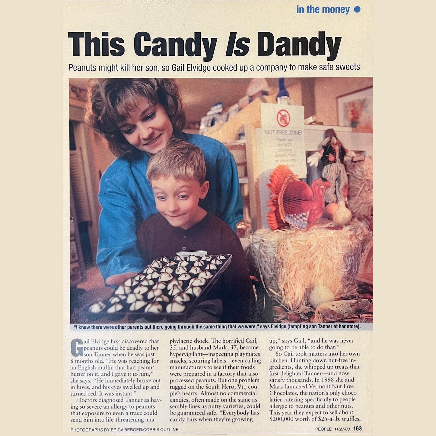 News article titled 'The Candy Is Dandy' picture showing mother and son admiring a box of white chocolate truffles