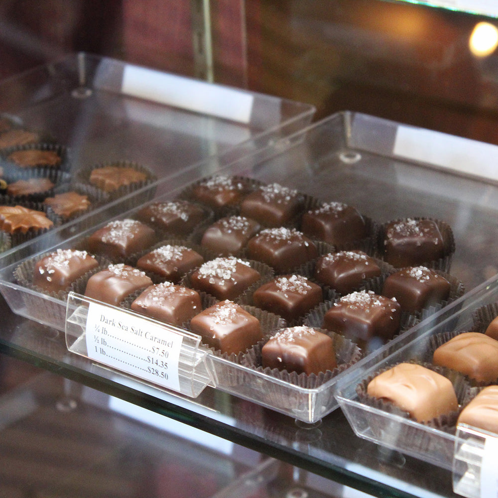 Glass candy case filled with caramels and other chocolates
