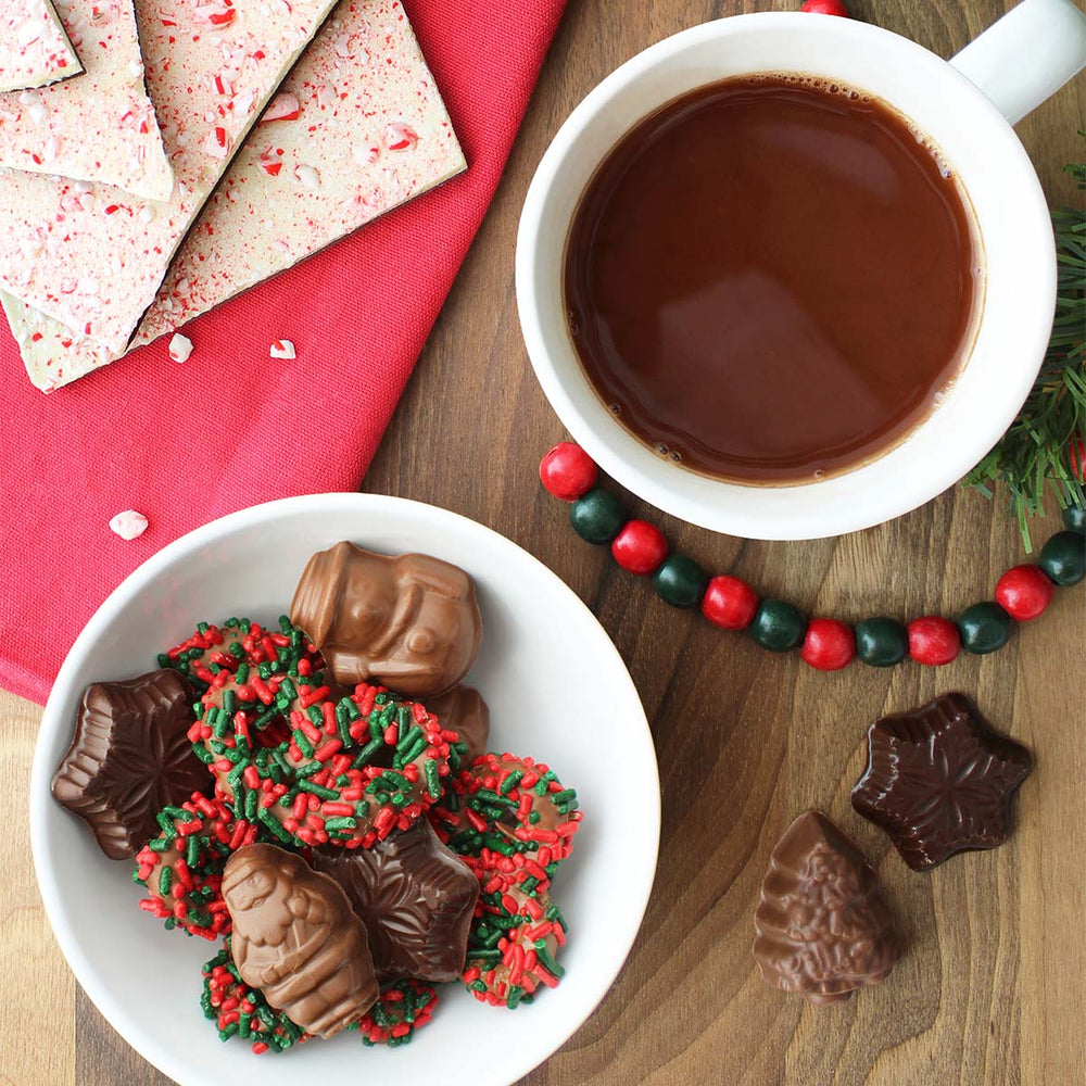 Assorted chocolates and a cup of hot cocoa shot from above. 